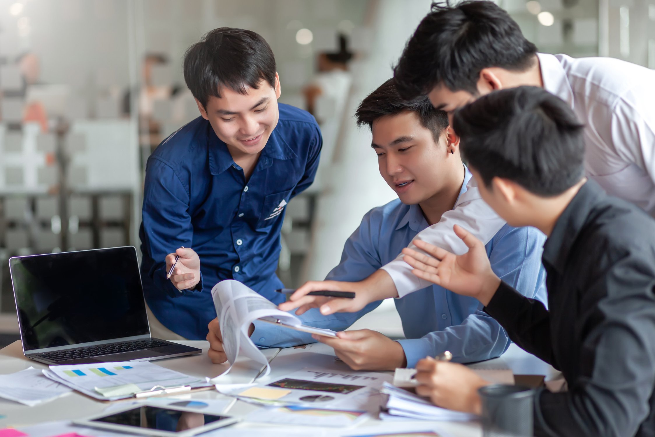 Meeting of young asian business people who are committed to work