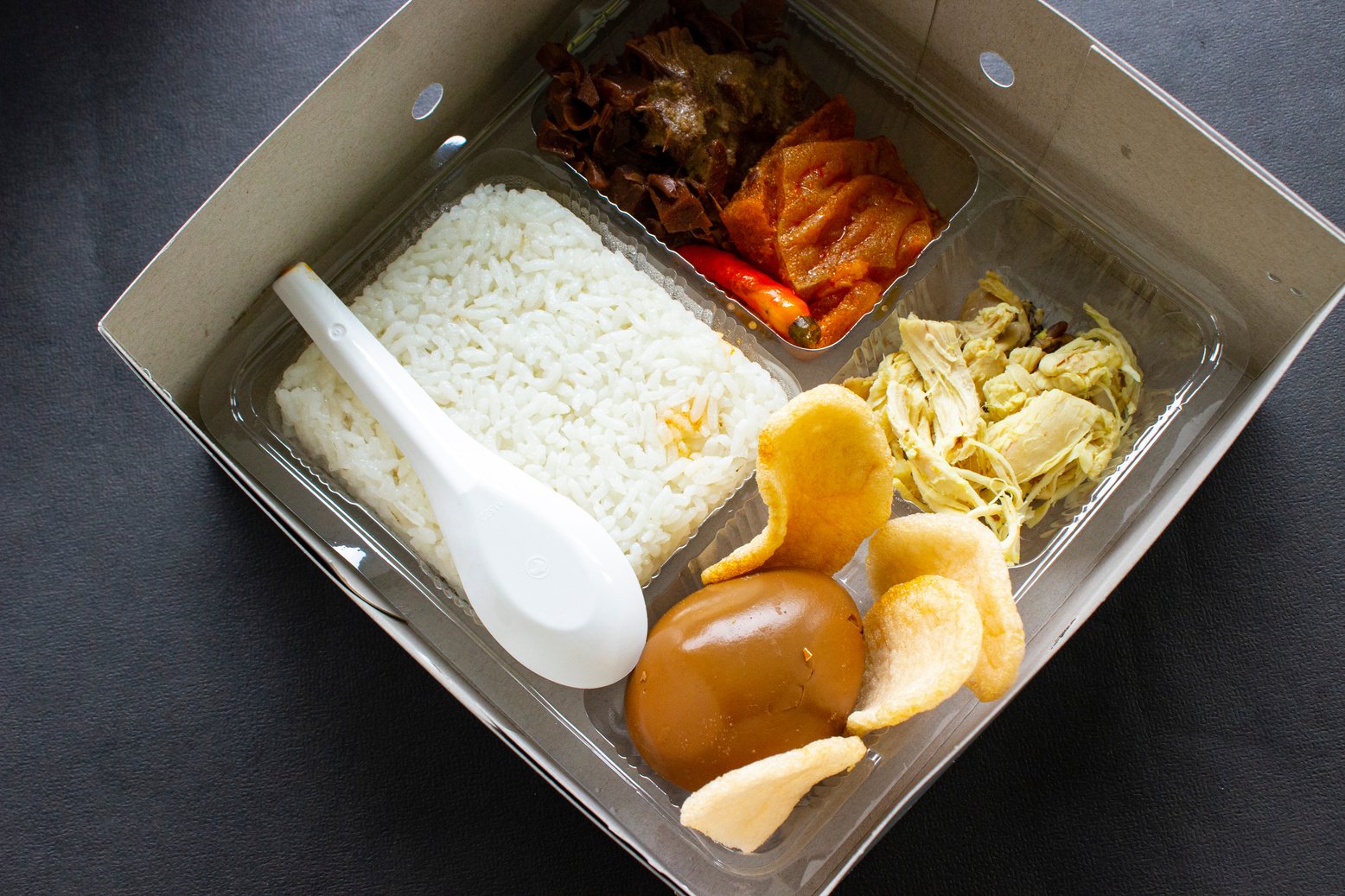 lunch boxes gudeg are similar to Bento boxes - rice boxes, rice, catering boxes, food services (rice warm, sweet eggs, krecek, tofu, tempeh, pieces of chicken,)